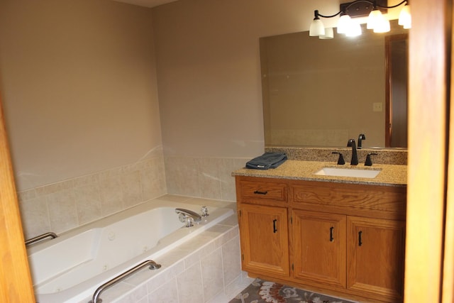 bathroom featuring tiled bath and vanity