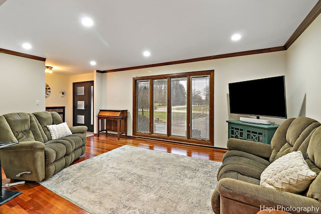 living room with hardwood / wood-style flooring and ornamental molding