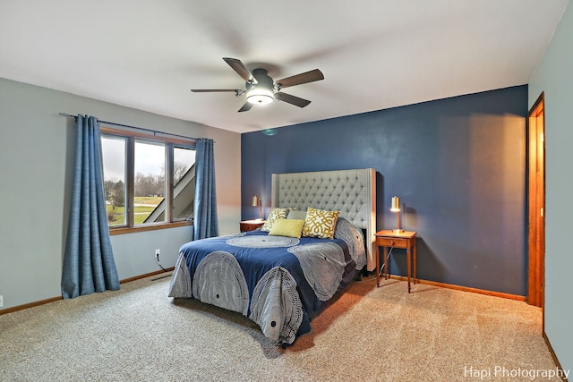 bedroom featuring ceiling fan and carpet