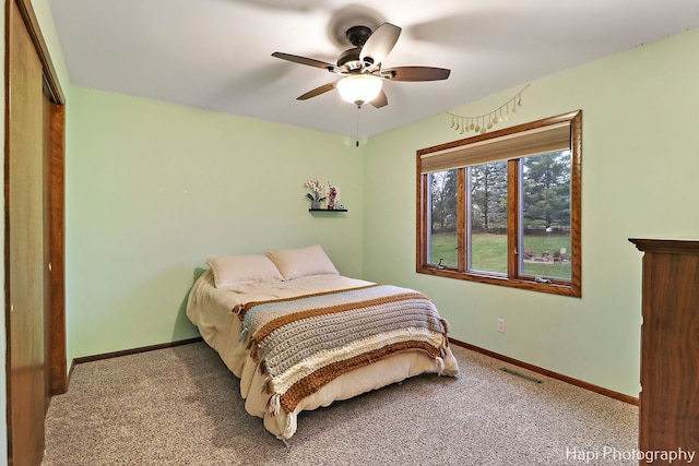 bedroom featuring light carpet, a closet, and ceiling fan