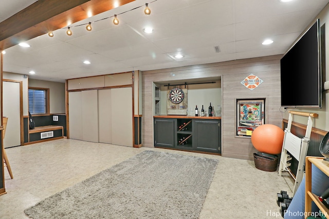 interior space featuring bar area and wood walls