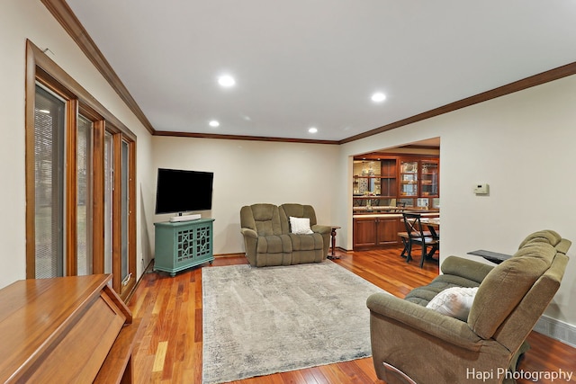 living room featuring wood-type flooring and ornamental molding