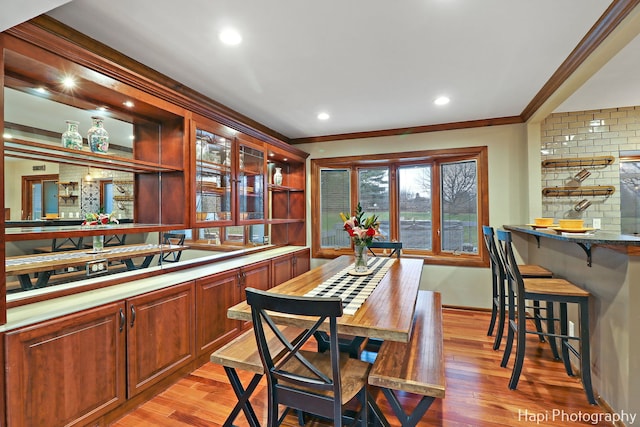 interior space with light hardwood / wood-style flooring and ornamental molding