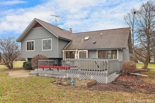 rear view of house with a yard and a wooden deck