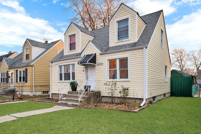 cape cod home with a front lawn