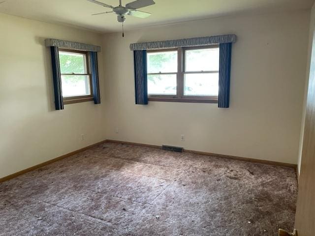 empty room featuring plenty of natural light and ceiling fan