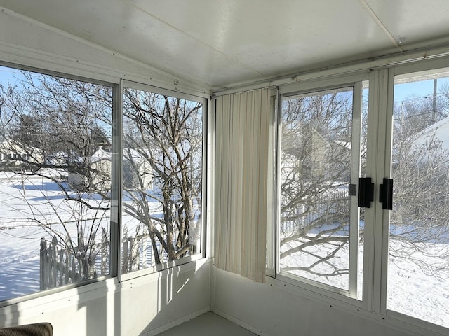 unfurnished sunroom with lofted ceiling