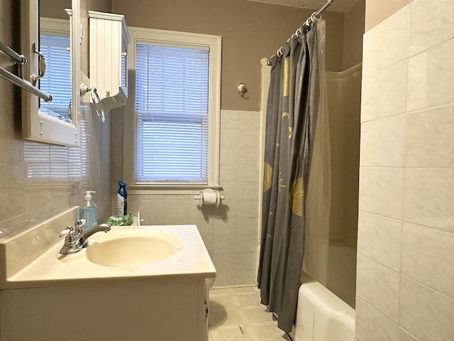 bathroom featuring tile walls, shower / tub combo, and vanity