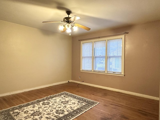 spare room featuring ceiling fan and dark hardwood / wood-style flooring