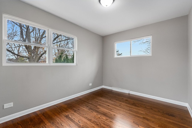 unfurnished room featuring hardwood / wood-style flooring