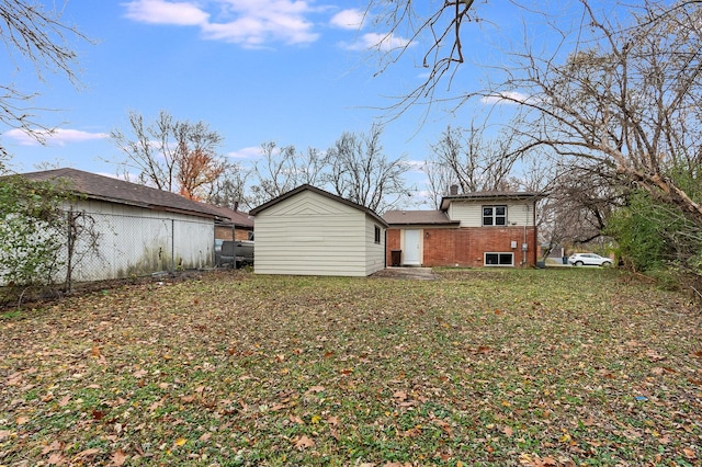 back of property featuring a lawn