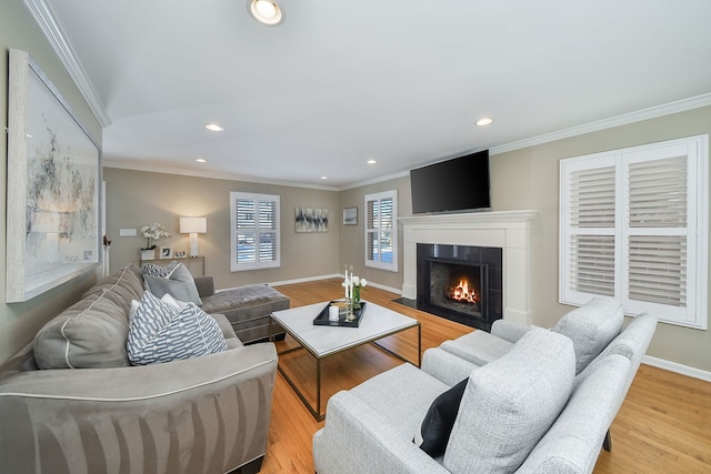 living room with light hardwood / wood-style floors and ornamental molding