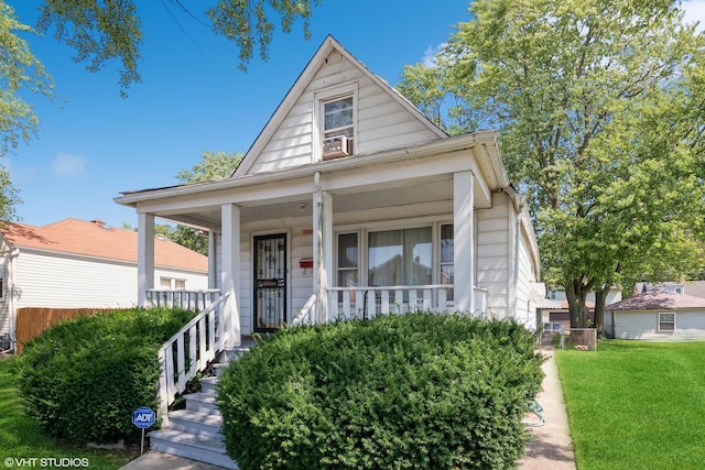 view of front of home featuring a front yard and covered porch