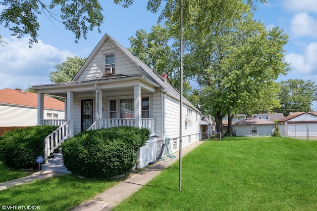 view of front of home with a porch and a front yard