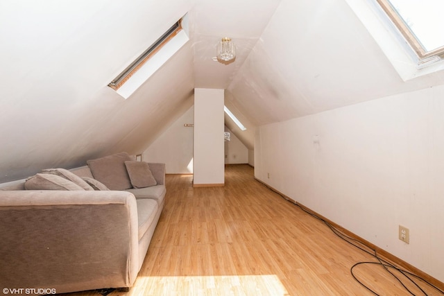 additional living space featuring light hardwood / wood-style flooring and lofted ceiling