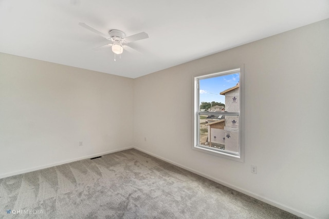 spare room with carpet floors and ceiling fan