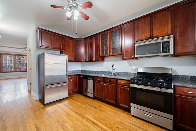 3022 N Hamilton Ave, Chicago, IL 60618 - kitchen with a sink, glass insert cabinets, ceiling fan, stainless steel appliances, and light wood finished floors