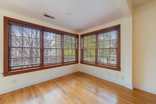 3022 N Hamilton Ave, Chicago, IL 60618 - spare room featuring visible vents, light wood finished floors, and baseboards