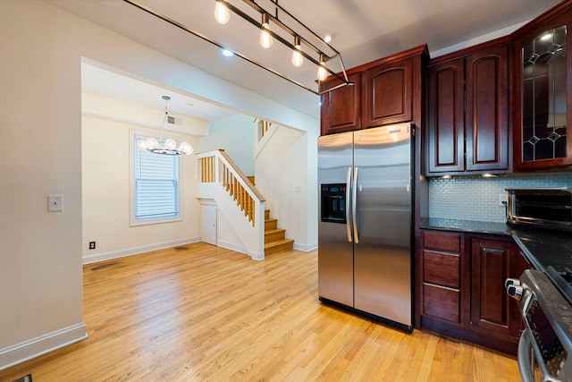 3022 N Hamilton Ave, Chicago, IL 60618 - kitchen featuring a toaster, stainless steel fridge with ice dispenser, backsplash, baseboards, and a notable chandelier