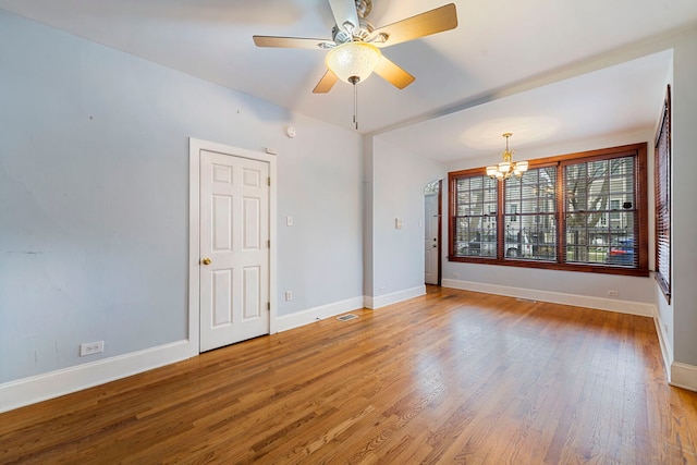 3022 N Hamilton Ave, Chicago, IL 60618 - spare room featuring baseboards, wood finished floors, and ceiling fan with notable chandelier