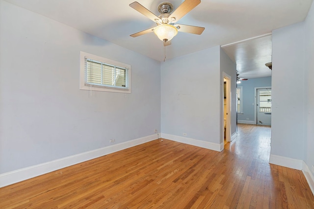 3022 N Hamilton Ave, Chicago, IL 60618 - empty room with light wood-style floors, a ceiling fan, and baseboards