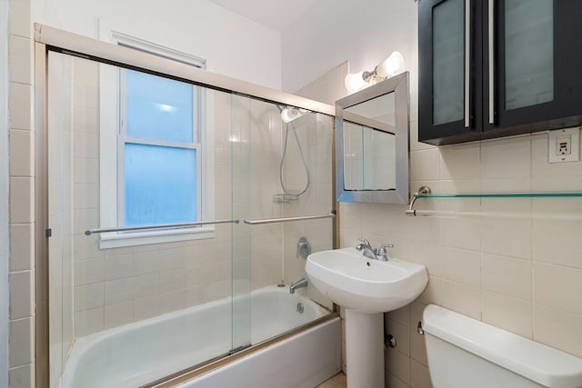 3022 N Hamilton Ave, Chicago, IL 60618 - bathroom with tasteful backsplash, a sink, tile walls, toilet, and shower / bath combination with glass door