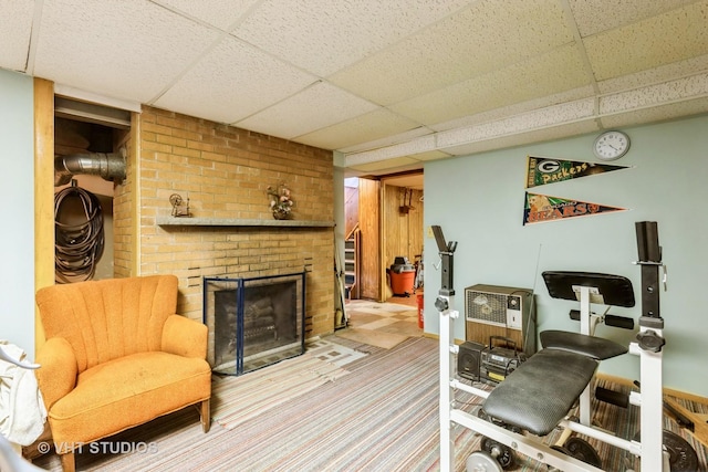 interior space featuring a fireplace, carpet, and a paneled ceiling