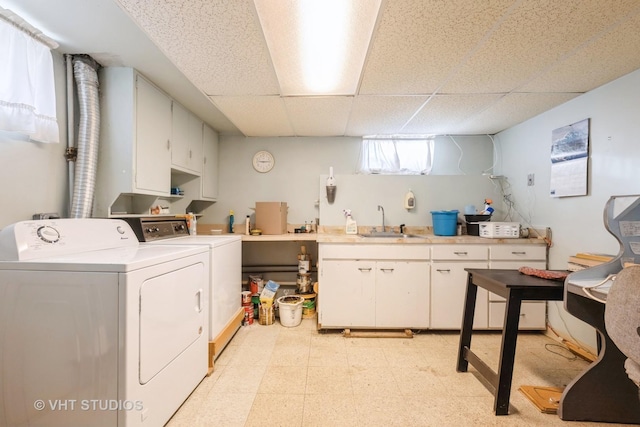 laundry area with washer and dryer, cabinets, and sink