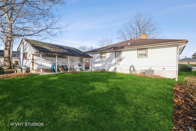 back of house featuring a yard and cooling unit