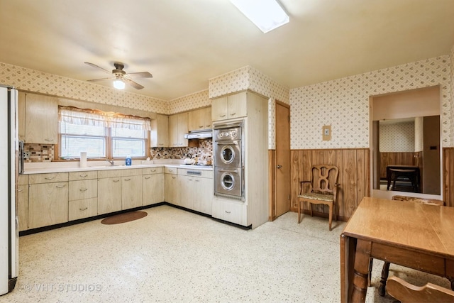 kitchen with light brown cabinets, sink, ceiling fan, stacked washer / drying machine, and gas cooktop