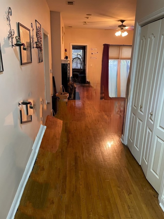 corridor with hardwood / wood-style flooring