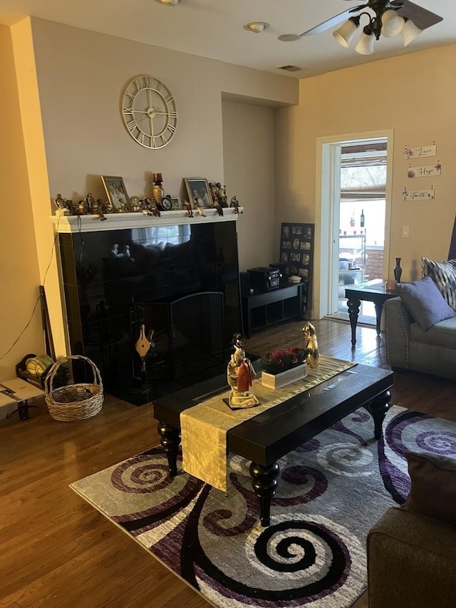 living room featuring ceiling fan and wood-type flooring