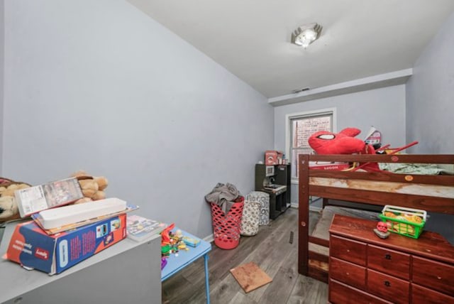 bedroom with hardwood / wood-style flooring