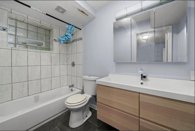 full bathroom with toilet, tiled shower / bath combo, tile patterned floors, and vanity