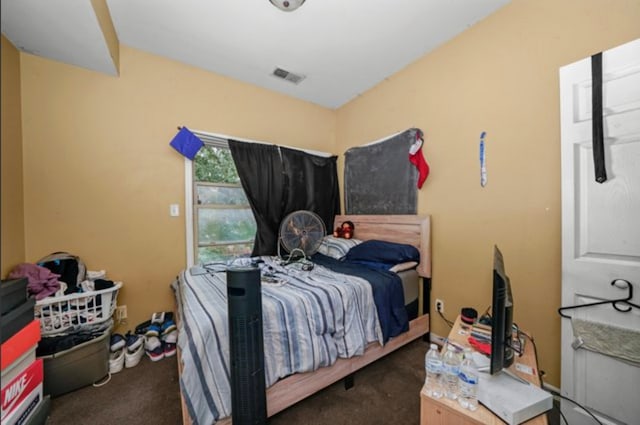 bedroom with dark colored carpet