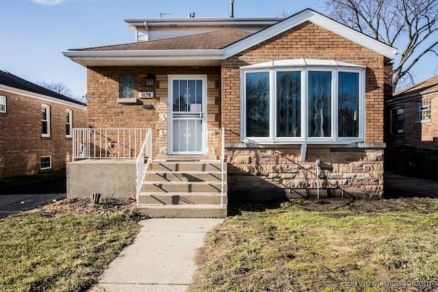 bungalow-style home featuring brick siding