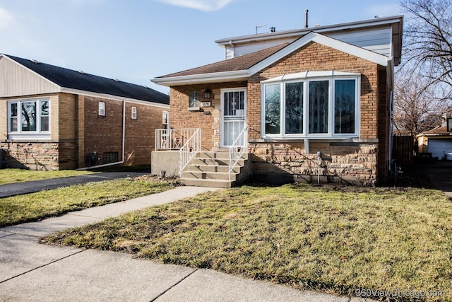 bungalow-style house with a front yard and brick siding