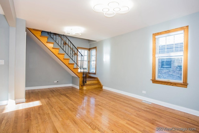 unfurnished living room featuring light wood-type flooring