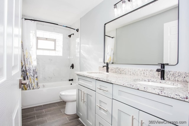 full bathroom featuring shower / bath combo, toilet, and vanity