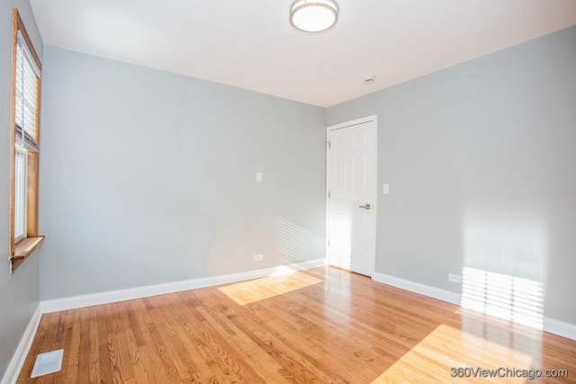 spare room with light hardwood / wood-style floors