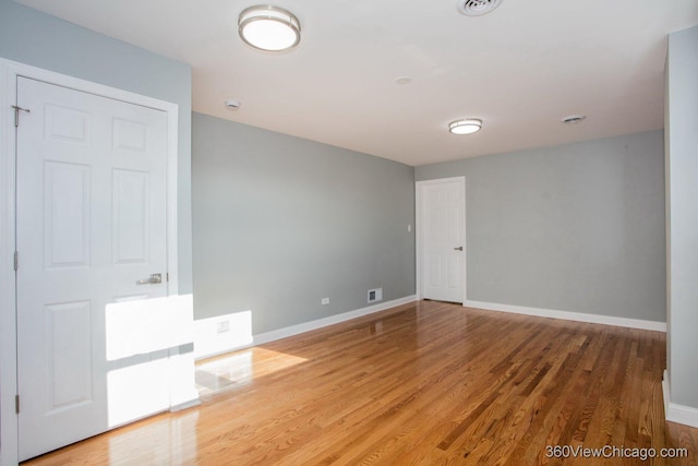 empty room with hardwood / wood-style flooring