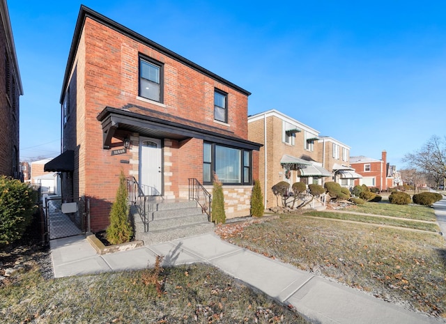 view of front of home with brick siding and a gate