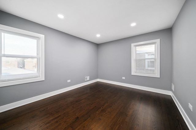 spare room featuring dark hardwood / wood-style flooring