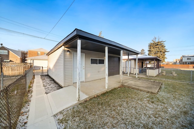 view of outdoor structure with a garage and a carport