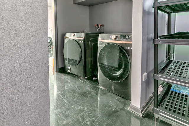 laundry area featuring washing machine and clothes dryer