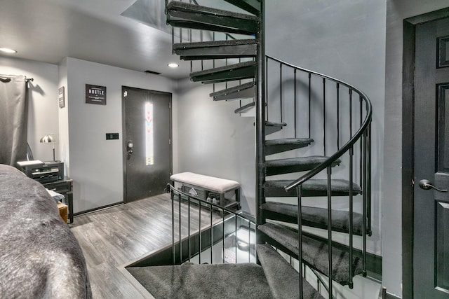 stairway featuring wood-type flooring