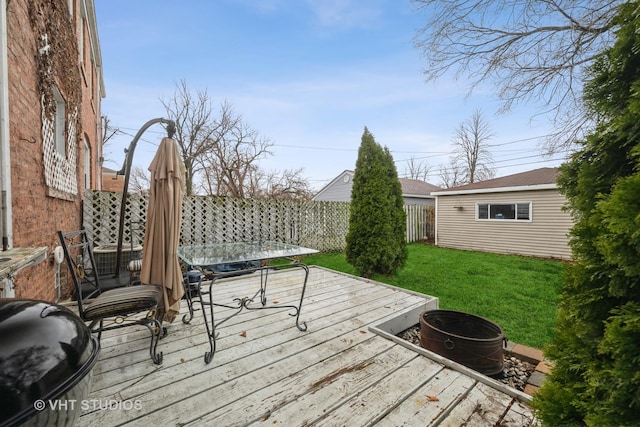 wooden deck with a lawn