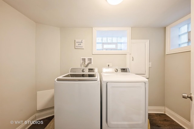 laundry area featuring washer and clothes dryer and dark wood-type flooring