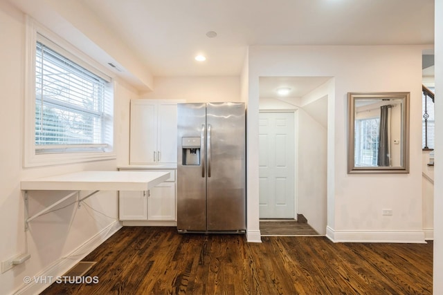 kitchen with vaulted ceiling, white cabinetry, dark wood-type flooring, and stainless steel refrigerator with ice dispenser