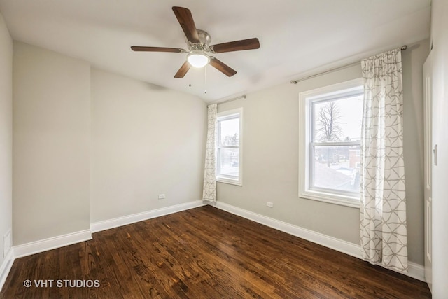 empty room with dark hardwood / wood-style floors and ceiling fan